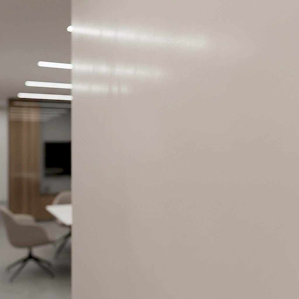 A photo of a glass wall in an office with a blurred office in the background.